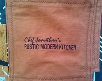 Embroidery on apron or pocket.