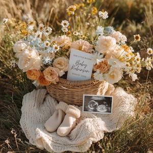 May include: A woven basket filled with peach, cream, and blue flowers, with a card saying "Our Little Bloom Baby Robinson August 2026." A knitted blanket, baby socks, and an ultrasound image are also present.