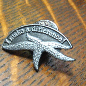 May include: A silver pin with a starfish design and the text "I make a difference!"