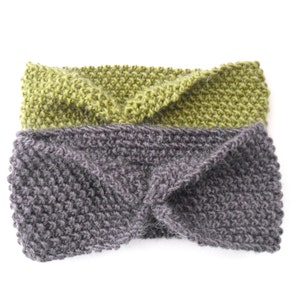 May include: Two knitted headbands. One is a muted green, the other is a dark gray. Both headbands are made of a thick, textured yarn and have a twisted design at the front. The headbands are displayed on a white background.