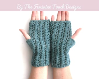 May include: A pair of teal blue knitted fingerless gloves. The gloves are made with a textured stitch pattern.  KNIT KIT By The Feminine Touch Designs.