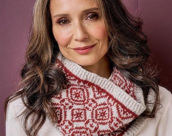 May include: A knitted cowl scarf featuring a repeating geometric pattern in deep red and light gray. The accessory has a ribbed texture along the top and bottom edges, with a thick, soft knit construction that sits comfortably around the neck area.
