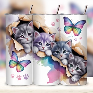 May include: Three white stainless steel tumblers with kitten and butterfly designs. Each tumbler features a different kitten peeking through a torn paper effect, with colorful butterflies and paw prints. The tumblers have a silver straw.