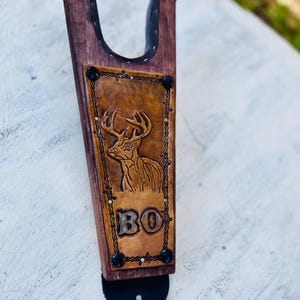 Könnte beinhalten: Eine weiße Keramik-Tasse mit schwarzem Henkel und dem Text "But First, Coffee" in fetter, schwarzer Schrift. Die Tasse steht vor einem neutralen Hintergrund, der ihr schlichtes Design hervorhebt.