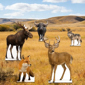 May include: Cardboard cutouts of wildlife animals including a moose, buffalo, deer, wolf, and fox. The animals are set against a backdrop of a grassy field and a blue sky with clouds.