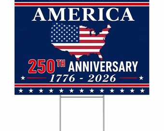 May include: A rectangular yard sign with a dark blue background, red and white stripes, and white stars. The text reads AMERICA 250TH ANNIVERSARY 1776 - 2026. A silhouette of the United States map filled with the American flag pattern is centred.