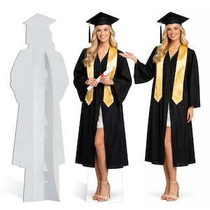 May include: Two women wearing black graduation gowns with gold stoles and mortarboard hats. One woman holds a diploma. A cardboard cutout of a graduate in a gown and mortarboard stands to the left.