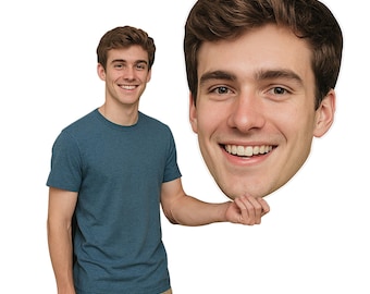 May include: A person in a blue t-shirt and beige trousers holds a large cutout of a smiling face. The cutout is a close-up of a person's face with brown hair and a wide smile.