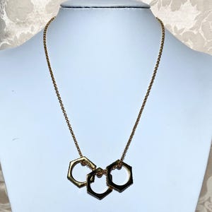 May include: A set of three ceramic mugs with a speckled, matte finish. The mugs are in shades of cream, light gray, and dark gray. Each mug has a simple, minimalist design and a rounded handle. The mugs are likely for coffee or tea.