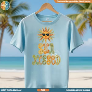 Peut inclure: T-shirt bleu clair avec un motif coloré d'un soleil portant des lunettes de soleil et l'inscription "Sun Kissed". Le motif comprend des détails orange, jaune et vert. Le t-shirt est suspendu à un cintre en bois.