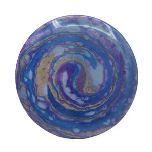 May include: A round, decorative object with a swirling pattern of blue, purple, and gold colors. The design resembles a galaxy or a watercolor painting. The object has a glossy finish and is set against a white background.