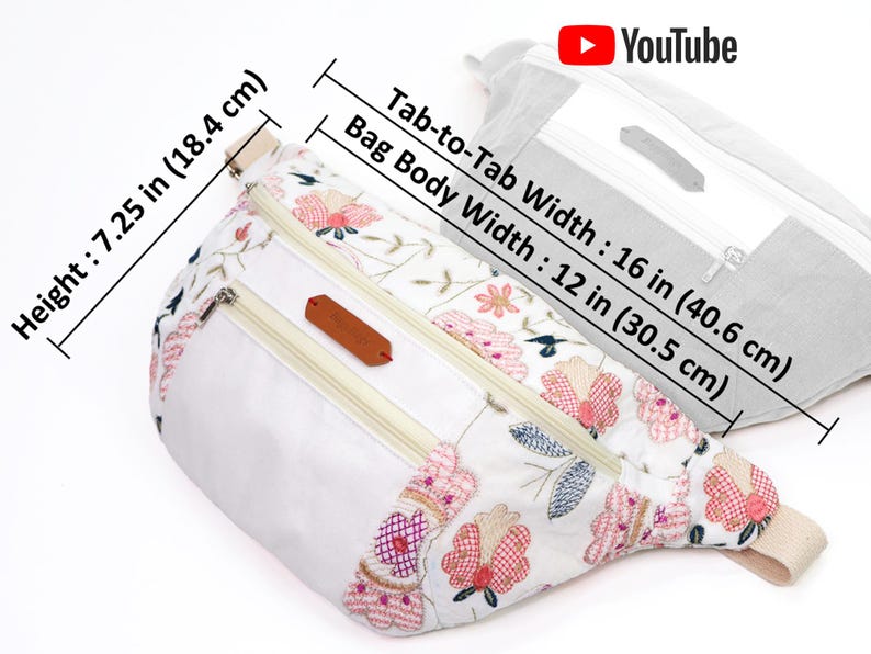 May include: White fanny pack with floral embroidery and two zippered compartments. The bag measures 7.25 inches tall and 16 inches wide.