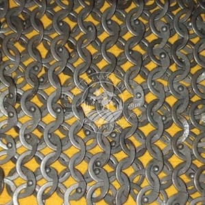May include: Close-up of chainmail armour, showing a dense pattern of interlocking metal rings. The background is yellow. A watermark with text and a crest is visible in the image.