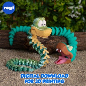 May include: A green and yellow articulated snake toy with a cartoon design. The snake has a detailed scale pattern and is posed on a sandy surface. The text "DIGITAL DOWNLOAD FOR 3D PRINTING" is visible.