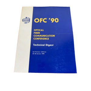 May include: A softcover book titled OFC '90 Optical Fiber Communication Conference Technical Digest. The cover is blue with yellow text and a white vertical striped panel on the left featuring a blue spiral icon. San Francisco, January 1990.
