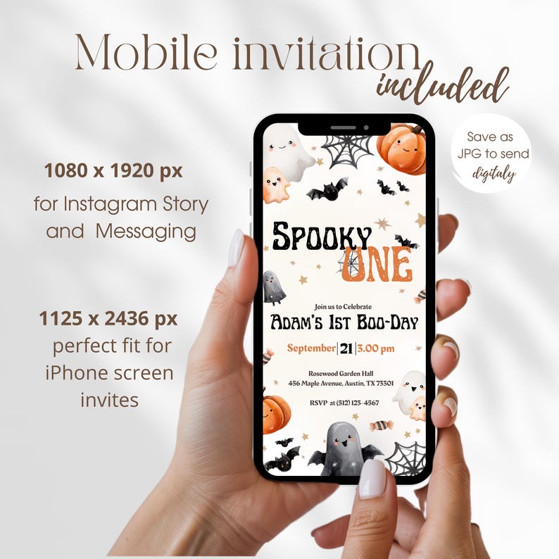 May include: A mobile phone screen shows a Halloween party invitation with the words "Spooky One". The design includes pumpkins, ghosts, and bats. The invitation is for "Adam's 1st Boo-Day" with date and time details. The phone is held in a person's hand.