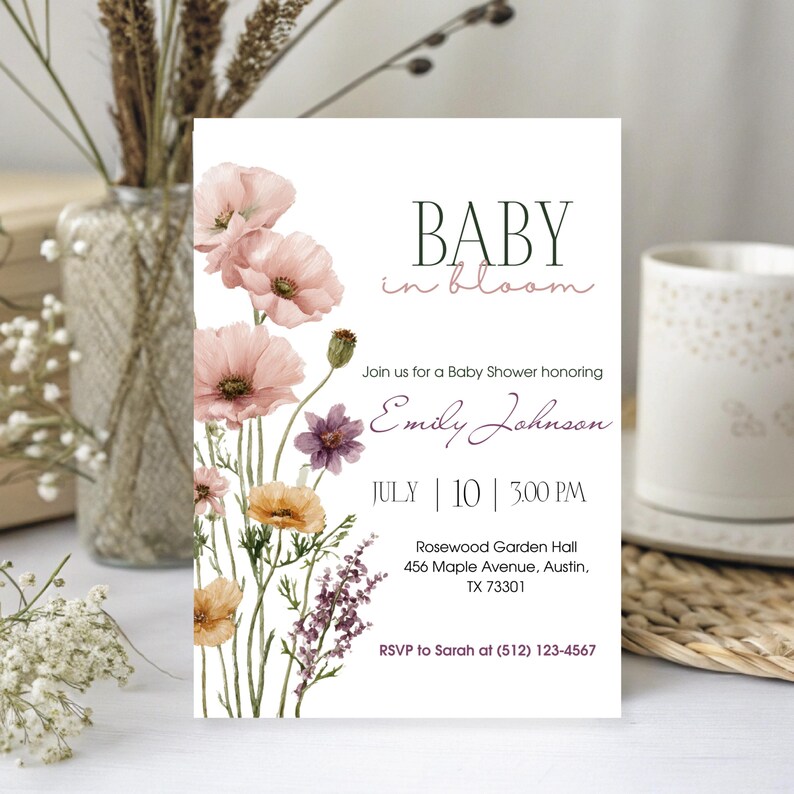 May include: A baby shower invitation with the text "BABY in bloom" and floral watercolor illustrations in pink, purple, and yellow. The invitation includes the date, time, and location of the event.