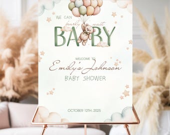 May include: A baby shower sign with a watercolor design. The sign features the text "We can bearly wait BABY" with a teddy bear holding balloons. The sign also includes the text "Welcome to Emily's Johnson Baby Shower" and the date "October 12th, 2025".