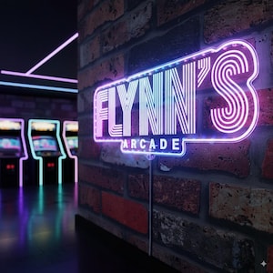 May include: A neon sign reading "FLYNN'S ARCADE" in a retro font, with a pink and blue gradient. The sign is fixed to a brick wall, with arcade machines visible in the background, creating a nostalgic atmosphere.