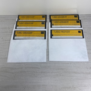 May include: A set of eight 3.5-inch floppy disks in white envelopes. The disks are labeled with the text "TURBO DEBUGGER", "TURBO ASSEMBLER", and "TURBO PROFILER".