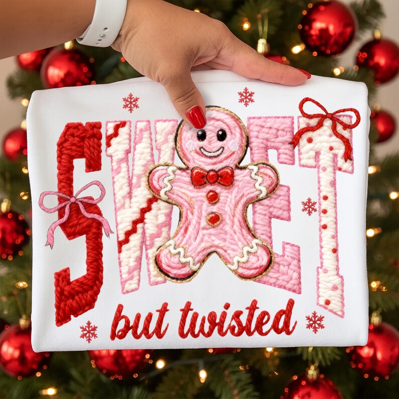 May include: White t-shirt with a pink gingerbread man and the words "SWEET but twisted" in red. The design includes red bows and snowflakes, perfect for the holiday season.