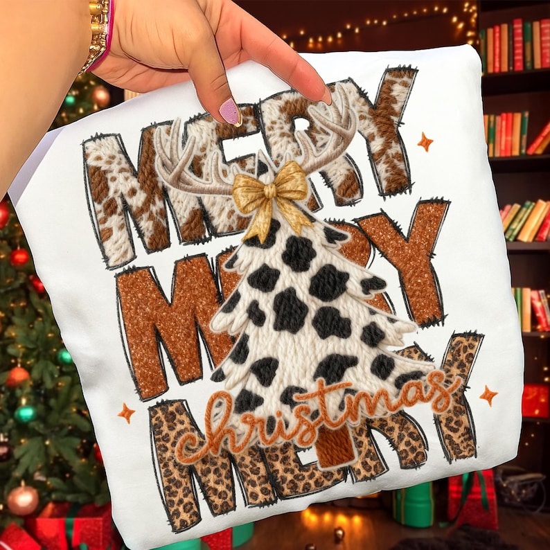 May include: White sweatshirt with the words "MERRY MERRY CHRISTMAS" in brown, cow print, and leopard print. A cow print Christmas tree with a gold bow and antlers is in the center.