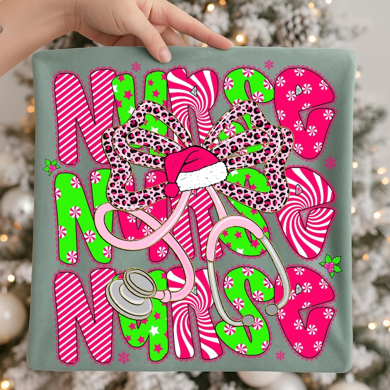 May include: A decorative pillow with the word "NURSE" in pink and green, featuring a stethoscope and a Santa hat. The letters have a candy cane and star pattern. A leopard print bow is in the center. The pillow is held by a hand.