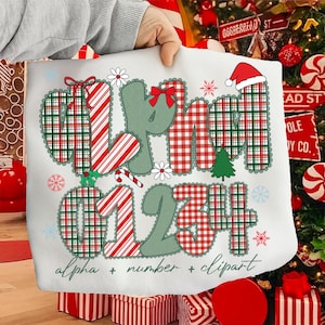 May include: White Christmas-themed graphic with the words "MERRY" and numbers "01234" in a plaid pattern. The design includes a Santa hat, snowflakes, and the text "alpha + number + clipart".