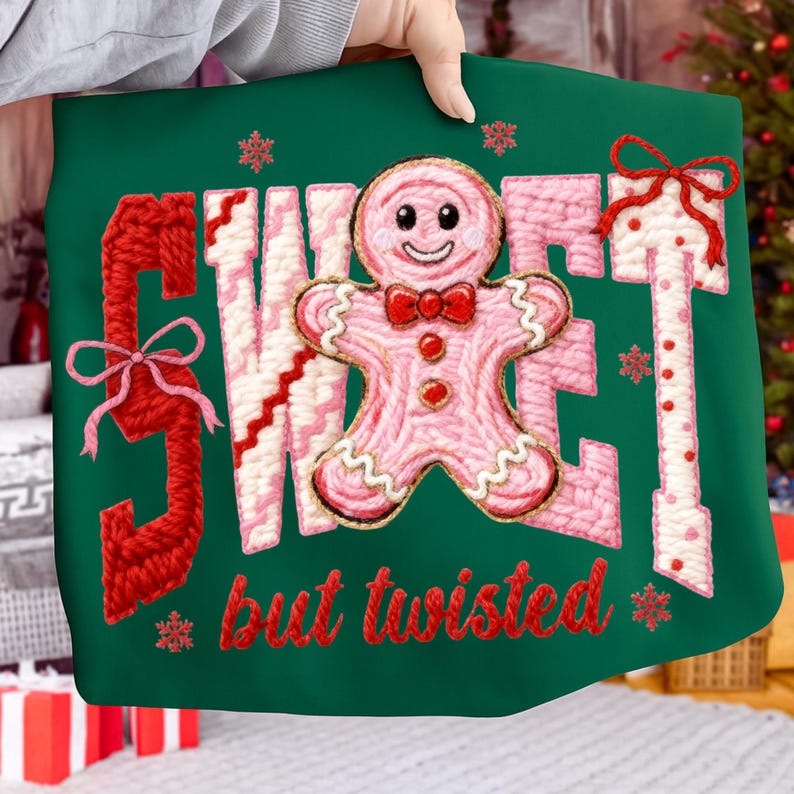 May include: A green Christmas-themed pillow with the words "SWEET" and "T" in red, and "W" and "E" in pink and white. A pink gingerbread man with a red bow tie is in the center. The words "but twisted" are in red.