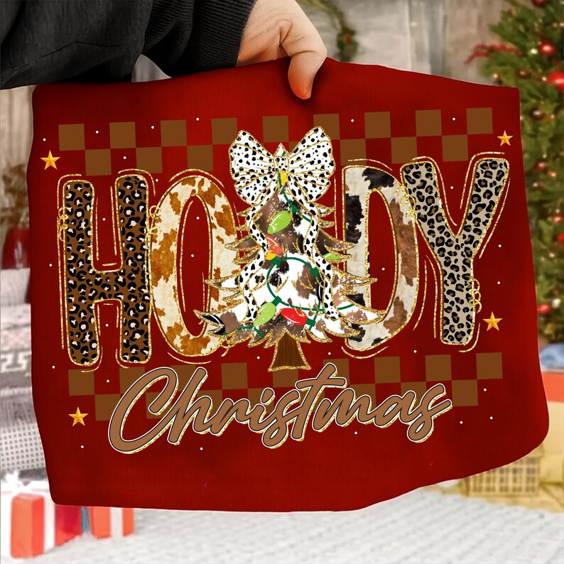 May include: Red Christmas-themed design with the words "HOLLY Christmas" in a mix of leopard and cow print. A Christmas tree with lights and a bow is in the center. Gold stars and brown checkered squares complete the design.