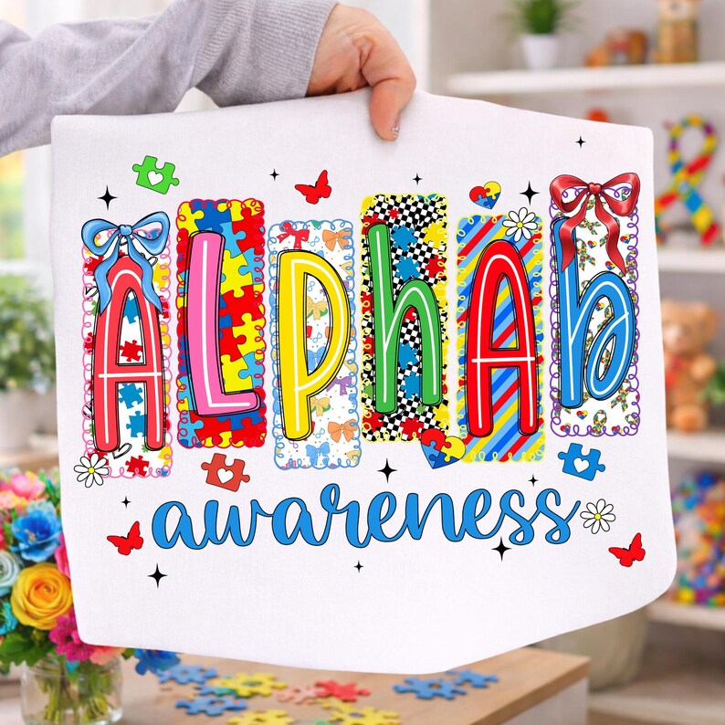 May include: White fabric featuring the word "ALPHA" in vibrant, puzzle-piece-style letters, and the word "awareness" in blue script. The design incorporates butterflies, puzzle pieces, and floral details, promoting autism awareness.