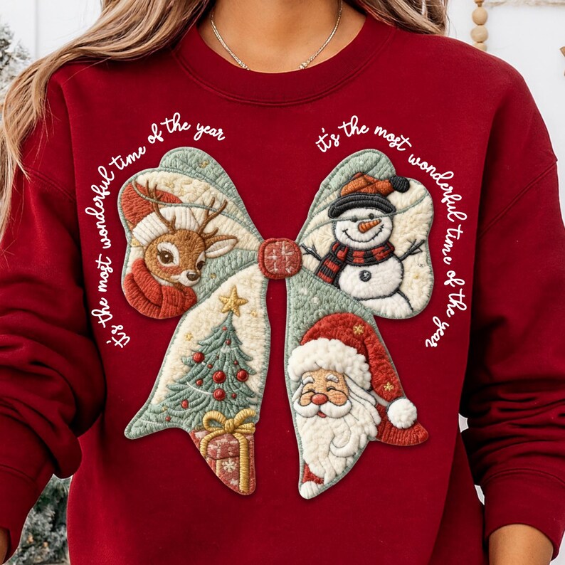 May include: A burgundy sweatshirt featuring a large bow design with Christmas-themed embroidered patches. The patches include a reindeer, snowman, Christmas tree, gift, and Santa Claus. The text "It's the most wonderful time of the year" is written around the bow.