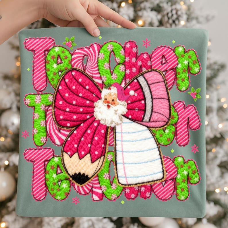 May include: A teal pillow with the word "Teacher" in pink and green candy cane style letters. A large pink bow with white polka dots and a Santa Claus face is in the center. A pencil and notepad are also featured.