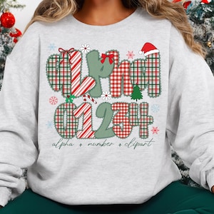 May include: A light gray sweatshirt featuring a festive design with the words "alpha + number + clipart". The design includes plaid letters and numbers in red, green, and white, along with snowflakes, candy canes, and a Santa hat. A Christmas-themed graphic.
