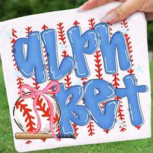 May include: White baseball-themed design with the word "ALPHABET" in blue bubble letters. A baseball with a pink bow and a wooden bat are featured. Red stitching and star accents complete the design.