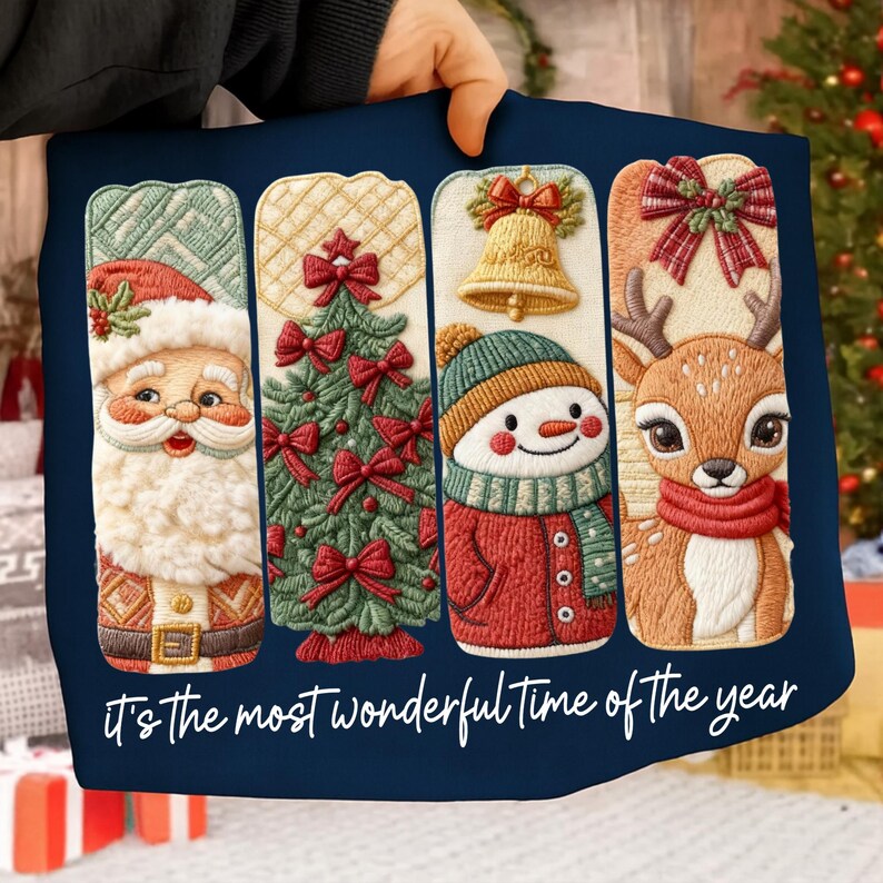 May include: A navy blue Christmas-themed pillow featuring embroidered designs of Santa Claus, a Christmas tree, a snowman, and a reindeer. The pillow has the text "It's the most wonderful time of the year" in white script.