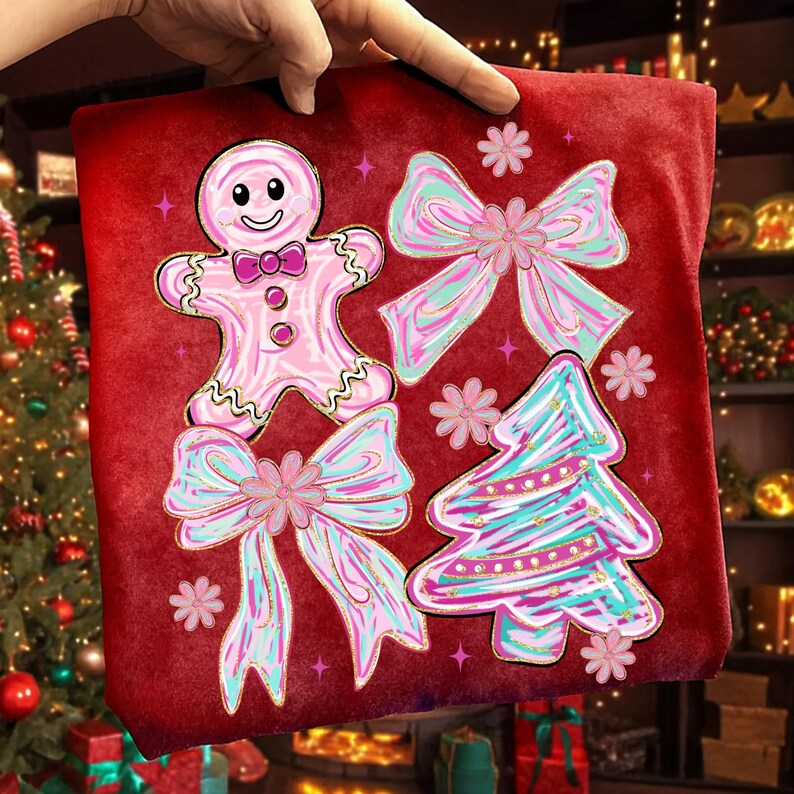 May include: A red Christmas cushion featuring a pink gingerbread man, two pink bows, and a teal and pink Christmas tree design. The cushion is decorated with pink stars and flowers, creating a festive holiday theme.
