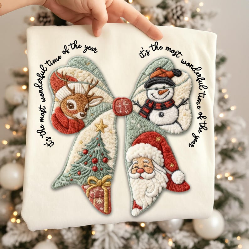 May include: Cream-colored Christmas-themed fabric with an embroidered bow design. The bow features a reindeer, snowman, Christmas tree, and Santa Claus. Text reads "It's the most wonderful time of the year."