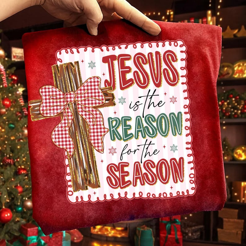 May include: Red Christmas pillow with the text "JESUS is the REASON for the SEASON". The pillow features a gold cross with a red and white plaid bow. Snowflakes and decorative border complete the design.
