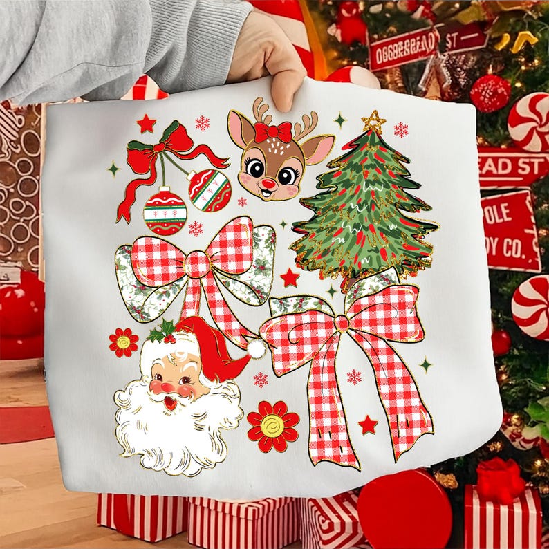 May include: White tote bag with Christmas illustrations. The design includes a reindeer with a red bow, a Christmas tree, Santa Claus, red and white plaid bows, ornaments, and stars. The bag is held by a person.