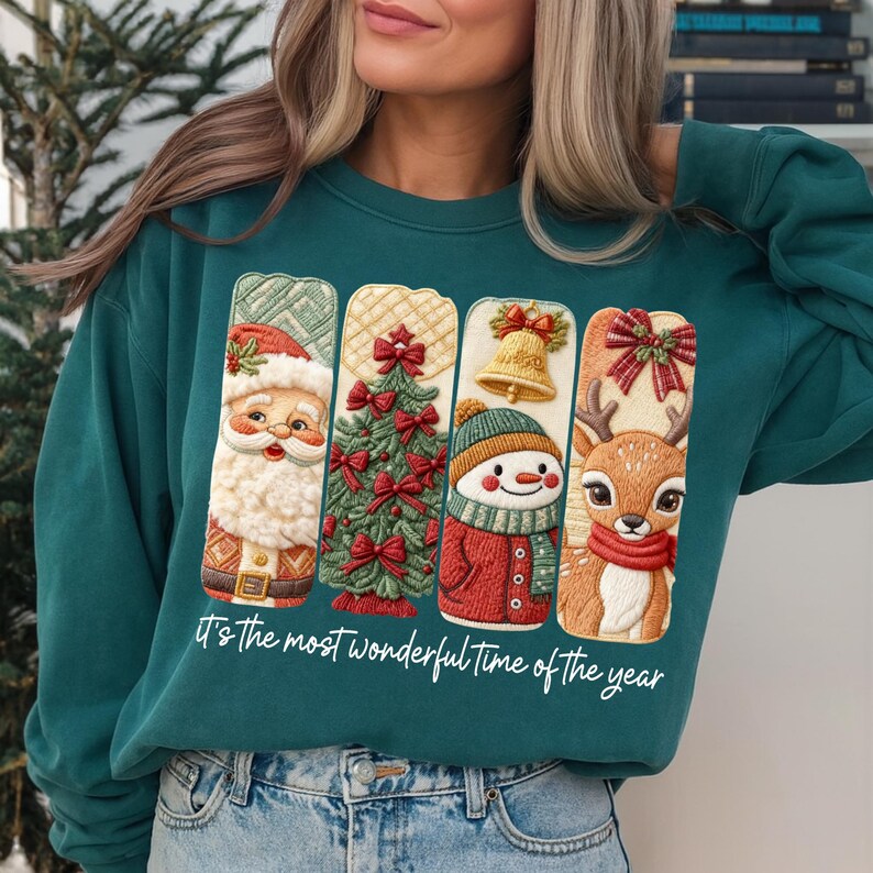 May include: Teal green sweatshirt featuring four Christmas-themed designs: Santa Claus, a Christmas tree, a snowman, and a reindeer. Each design is in a vertical rectangle. The text "It's the most wonderful time of the year" is printed at the bottom.