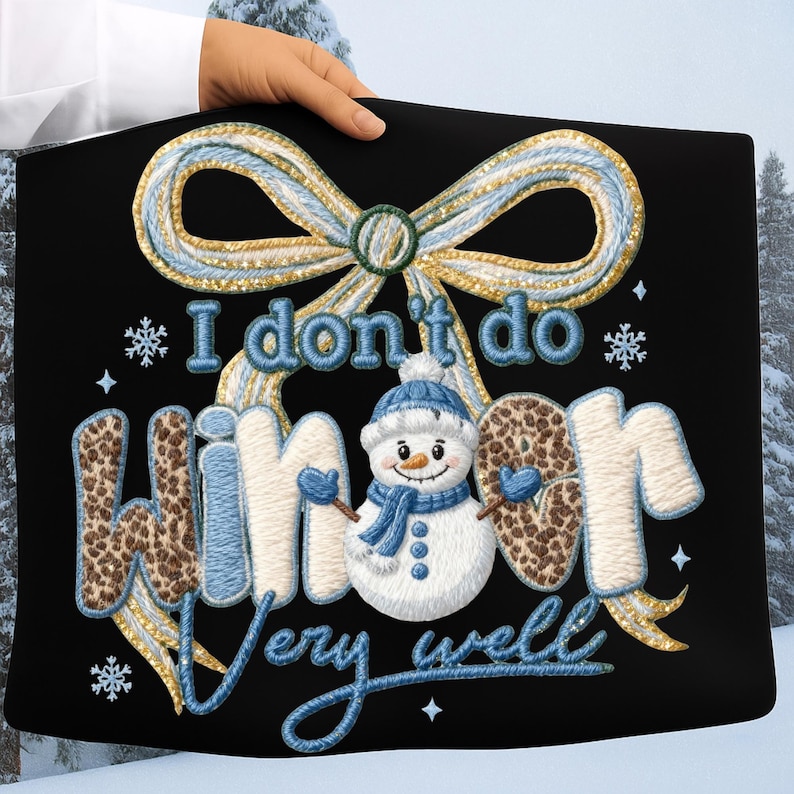 May include: Black tote bag with an embroidered design featuring a snowman, snowflakes, and the phrase "I don't do winter very well." The design includes a blue and gold bow and lettering.