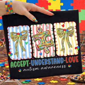 May include: Black canvas featuring three framed designs with striped backgrounds and a bow or puzzle piece. The text "ACCEPT UNDERSTAND LOVE" and "autism awareness" are printed in green and white.