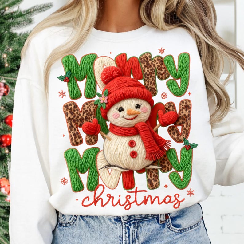 May include: White sweatshirt with a festive Christmas design. The design features the words "Merry Merry Merry Christmas" in green and leopard print, with a snowman wearing a red hat, scarf, and mittens. Snowflakes and holly accents complete the holiday theme.