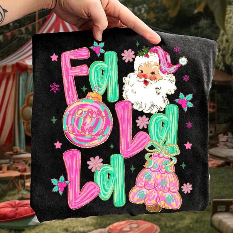 May include: Black t-shirt with a Christmas-themed design. The design features the words "F L O L L L O L" in pink and teal, along with a Santa Claus illustration, a Christmas tree, and ornaments.