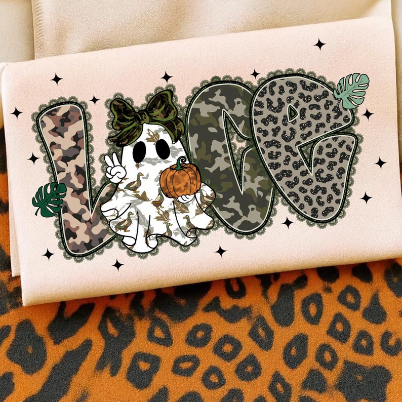 May include: A light pink Halloween-themed graphic featuring the word "LOVE" with a ghost character holding a pumpkin. The letters have camouflage and leopard print patterns. The ghost is wearing a bow and giving a peace sign.