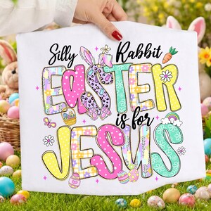 May include: White Easter-themed graphic featuring the text "Silly Rabbit Easter is for Jesus." The word "Easter" is in pink, purple, and yellow, with a bunny and Easter egg designs. The word "Jesus" is in pink and yellow.