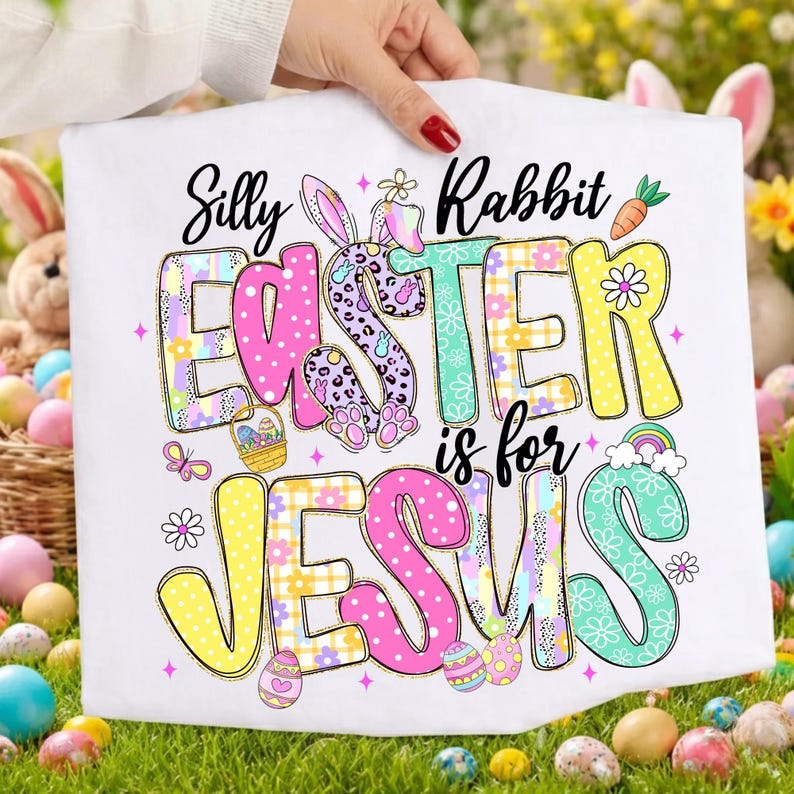 May include: White Easter-themed graphic featuring the text "Silly Rabbit Easter is for Jesus." The word "Easter" is in pink, purple, and yellow, with a bunny and Easter egg designs. The word "Jesus" is in pink and yellow.