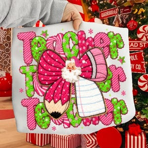 May include: A white tote bag with the words "Teacher" in green and pink, decorated with a pink bow, a Santa Claus, and a pencil. The bag is decorated with snowflakes and candy cane stripes, perfect for the holiday season.