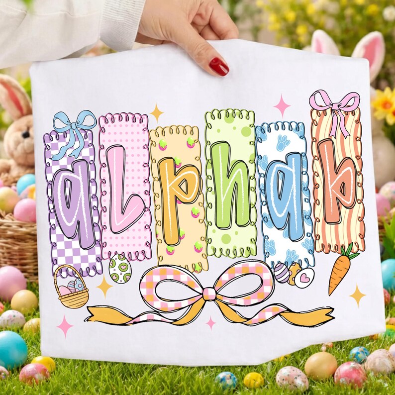 May include: White Easter-themed decorative banner with the word "ALPHA" in colorful, patterned letters. Each letter is outlined in a different color and decorated with bows, eggs, and a carrot. The banner is held by a person.
